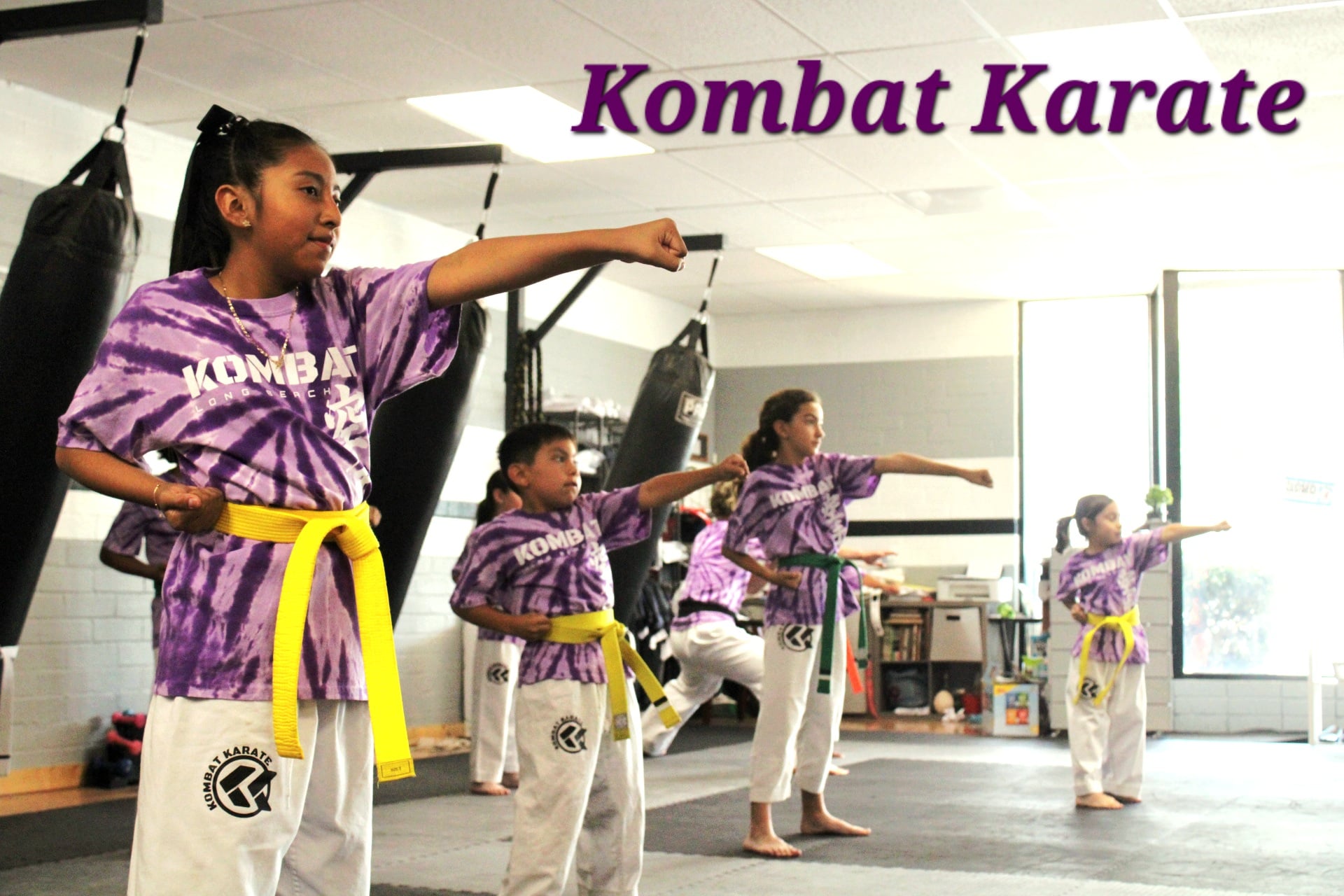 Karate student working striking combinations on focus mitts in Long Beach, CA