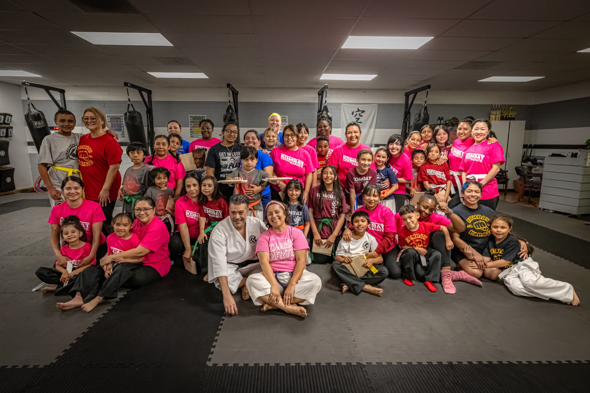 Kombat Karate students and families celebrating a board-breaking event together at the Long Beach dojo